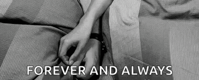 A Black And White Photo Of A Couple Holding Hands . GIF