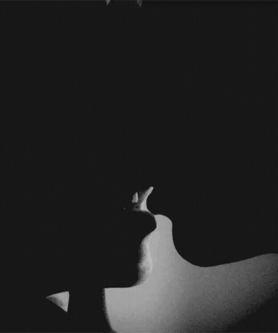 A Black And White Photo Of A Couple Kissing . GIF