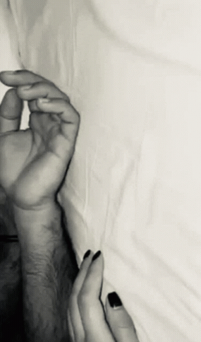 A Black And White Photo Of A Couple 'S Hands GIF