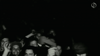 A Black And White Photo Of A Crowd Of People With The Letter F In The Upper Right Corner GIF