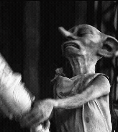 A Black And White Photo Of A Dobby From Harry Potter Standing Next To A Person . GIF