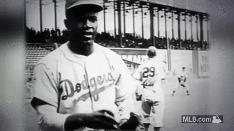A Black And White Photo Of A Dodgers Baseball Player Holding A Baseball Glove . GIF