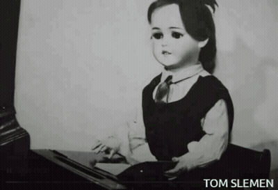 A Black And White Photo Of A Doll With The Name Tom Slemen Underneath It GIF