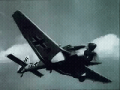 A Black And White Photo Of A Fighter Jet Flying Through The Sky . GIF