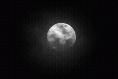 A Black And White Photo Of A Full Moon In The Night Sky GIF