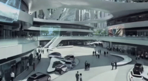 A Black And White Photo Of A Futuristic Building With Cars Parked GIF