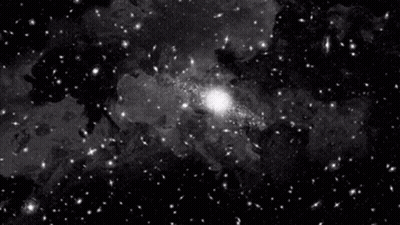 A Black And White Photo Of A Galaxy With A Lot Of Stars GIF