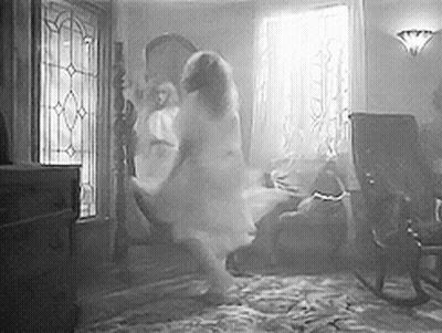 A Black And White Photo Of A Ghost Dancing In A Living Room . GIF