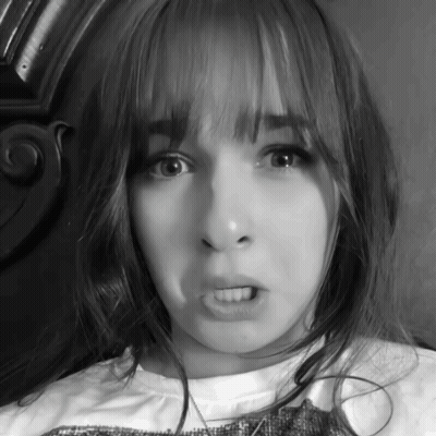 A Black And White Photo Of A Girl Making A Face GIF
