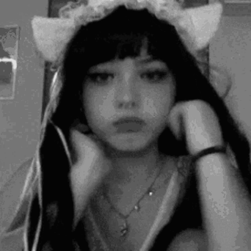 A Black And White Photo Of A Girl Wearing A Cat Ear Headband . GIF
