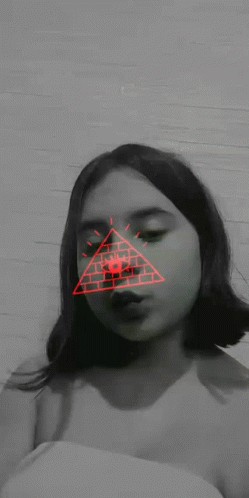 A Black And White Photo Of A Girl With A Red Triangle On Her Face GIF