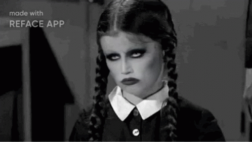 A Black And White Photo Of A Girl With Pigtails And A Serious Look On Her Face . GIF