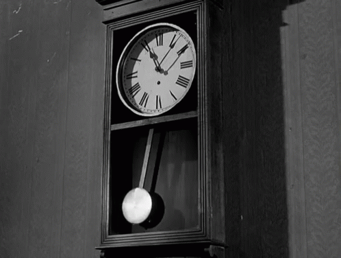 A Black And White Photo Of A Grandfather Clock GIF