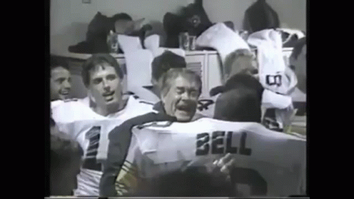 A Black And White Photo Of A Group Of Football Players One Of Whom Has The Name Bell On His Jersey GIF