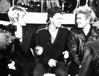 A Black And White Photo Of A Group Of Men In Leather Jackets GIF