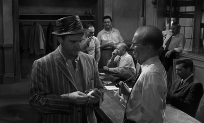 A Black And White Photo Of A Group Of Men Talking GIF
