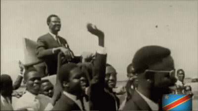 A Black And White Photo Of A Group Of Men With A Flag In The Corner GIF