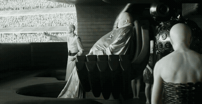 A Black And White Photo Of A Group Of People Including A Woman GIF