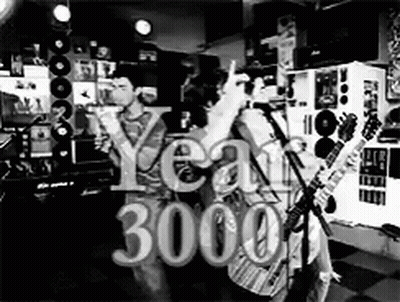 A Black And White Photo Of A Group Of People Playing Guitars And Singing Into Microphones . GIF