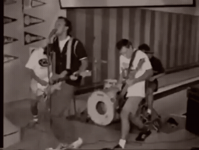 A Black And White Photo Of A Group Of People Playing Instruments . GIF