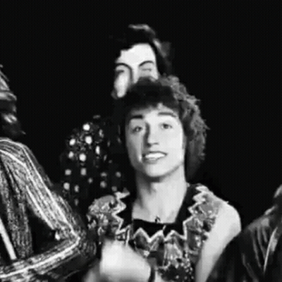 A Black And White Photo Of A Group Of People Standing Next To Each Other And Smiling . GIF