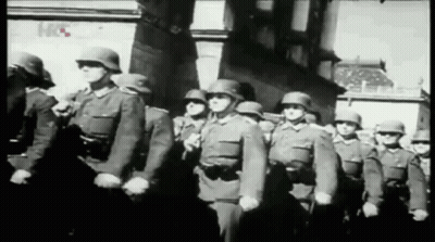 A Black And White Photo Of A Group Of Soldiers Marching In A Parade GIF