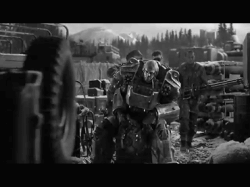 A Black And White Photo Of A Group Of Soldiers With A Robot In The Middle GIF