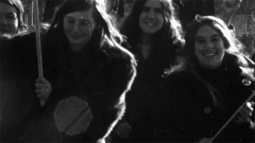A Black And White Photo Of A Group Of Young Women GIF