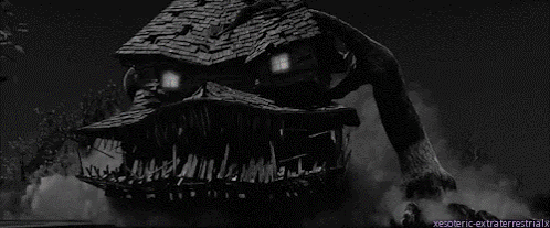 A Black And White Photo Of A House With A Monster Face On It GIF