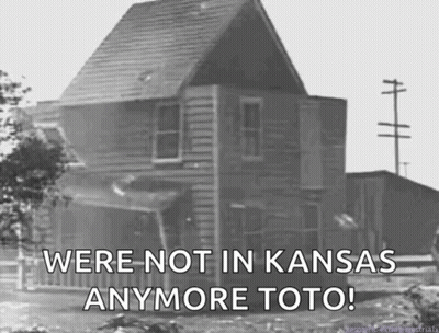 A Black And White Photo Of A House With The Words " We 'Re Not In Kansas Anymore Toto " GIF