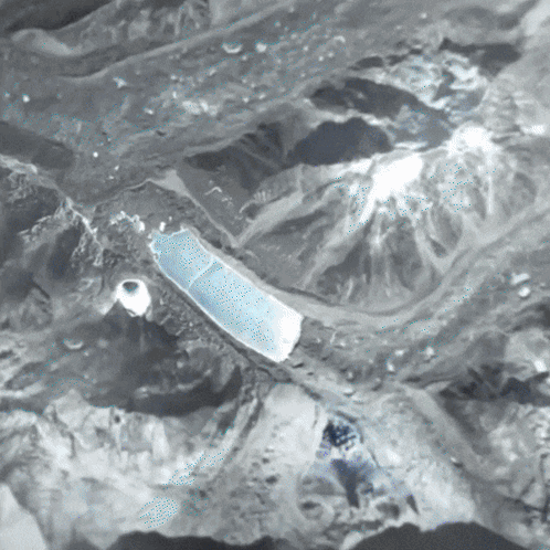 A Black And White Photo Of A Landscape With Mountains GIF
