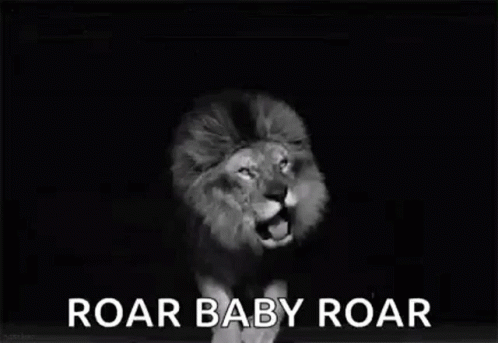 A Black And White Photo Of A Lion Roaring With The Words `` Roar Baby Roar '' Written Below It . GIF