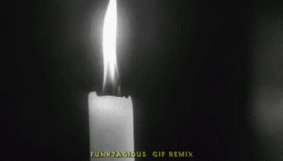 A Black And White Photo Of A Lit Candle With The Words Lights Out GIF