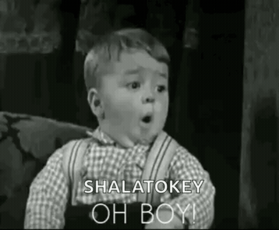 A Black And White Photo Of A Little Boy Making A Funny Face And Saying `` Shalatokey Oh Boy '' . GIF