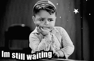 A Black And White Photo Of A Little Boy With The Words I 'M Still Waiting On The Bottom GIF