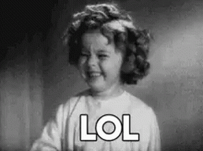 A Black And White Photo Of A Little Girl Laughing With The Word Lol Written On Her Face . GIF