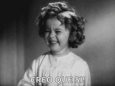 A Black And White Photo Of A Little Girl Laughing With The Words `` Creo Que Si '' Written Below Her . GIF