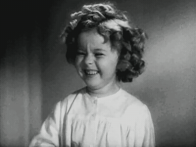 A Black And White Photo Of A Little Girl Laughing . GIF