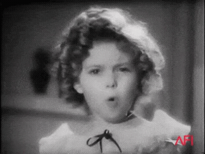 A Black And White Photo Of A Little Girl Making A Funny Face GIF