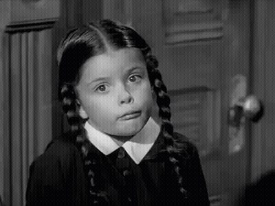 A Black And White Photo Of A Little Girl Making A Funny Face . GIF