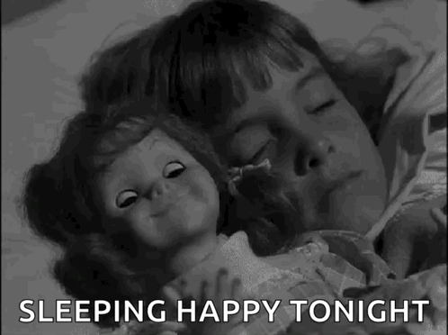 A Black And White Photo Of A Little Girl Sleeping With A Doll And The Words `` Sleeping Happy Tonight '' . GIF