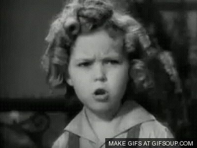 A Black And White Photo Of A Little Girl With Curlers In Her Hair Making A Face . GIF
