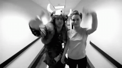 A Black And White Photo Of A Man And A Woman In A Hallway . GIF