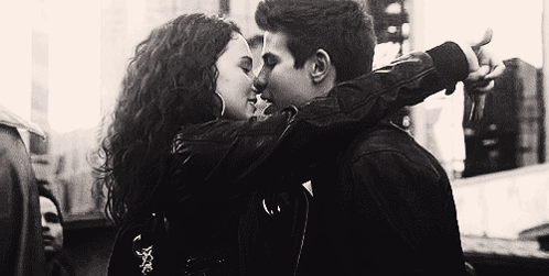 A Black And White Photo Of A Man And A Woman Kissing . GIF