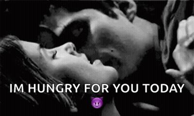 A Black And White Photo Of A Man And A Woman Kissing . GIF