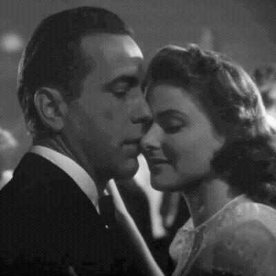A Black And White Photo Of A Man And A Woman Kissing GIF