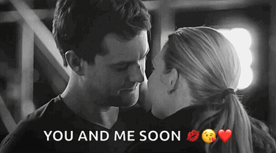 A Black And White Photo Of A Man And A Woman Kissing With The Words You And Me Soon Below Them GIF