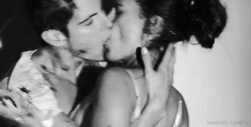 A Black And White Photo Of A Man And A Woman Kissing . GIF
