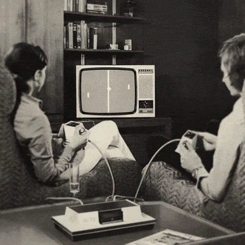 A Black And White Photo Of A Man And A Woman Playing A Video Game GIF