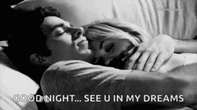A Black And White Photo Of A Man And A Woman Sleeping In A Bed . GIF
